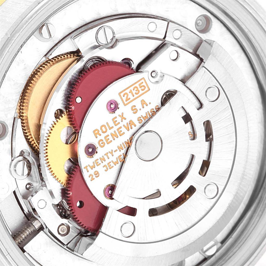 This image shows the intricate inner mechanism of a Rolex Mid-Size 68273 Women's Steel and Gold (two tone) White Dial 68273 Women's Steel and Gold (two tone) White Dial watch model, highlighting the gears and rotors.