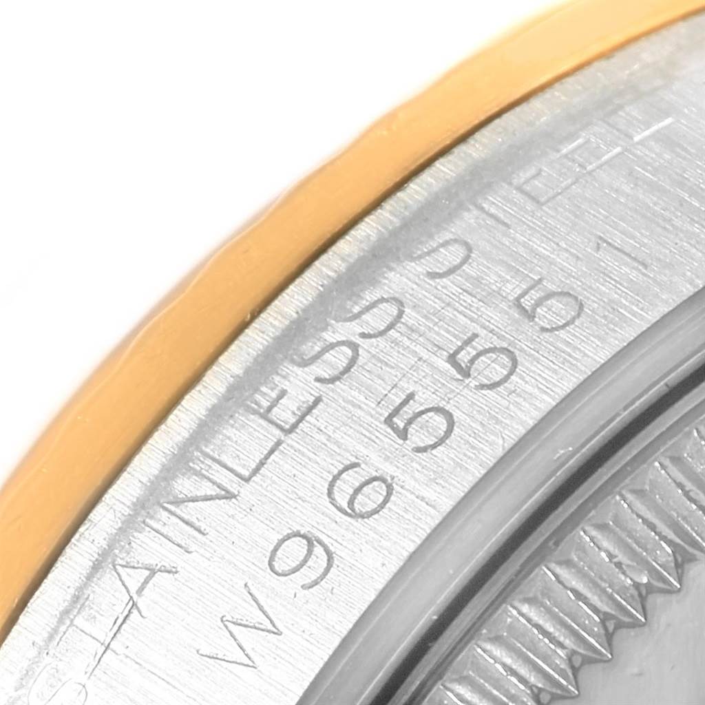The image shows a close-up of the edge of a stainless steel and gold bezel on a Rolex Mid-Size 68273 Women's Steel and Gold (two tone) White Dial 68273 Women's Steel and Gold (two tone) White Dial watch.