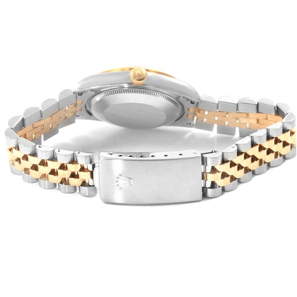 The image shows the back and bracelet of a mid-size Rolex watch, highlighting its clasp and case back.
