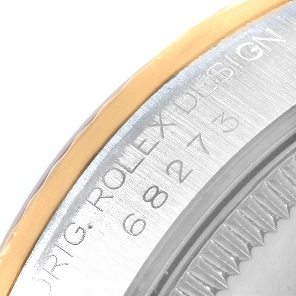 This image shows a close-up of the bezel and engraved details of a Rolex Mid-Size 68273 Women's Steel and Gold (two tone) White Dial 68273 Women's Steel and Gold (two tone) White Dial model watch.