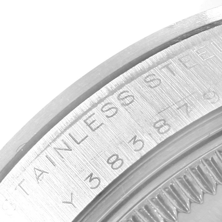 This image shows a close-up view of the stainless steel case back edge along with the serial number of a Mid-Size Rolex watch.