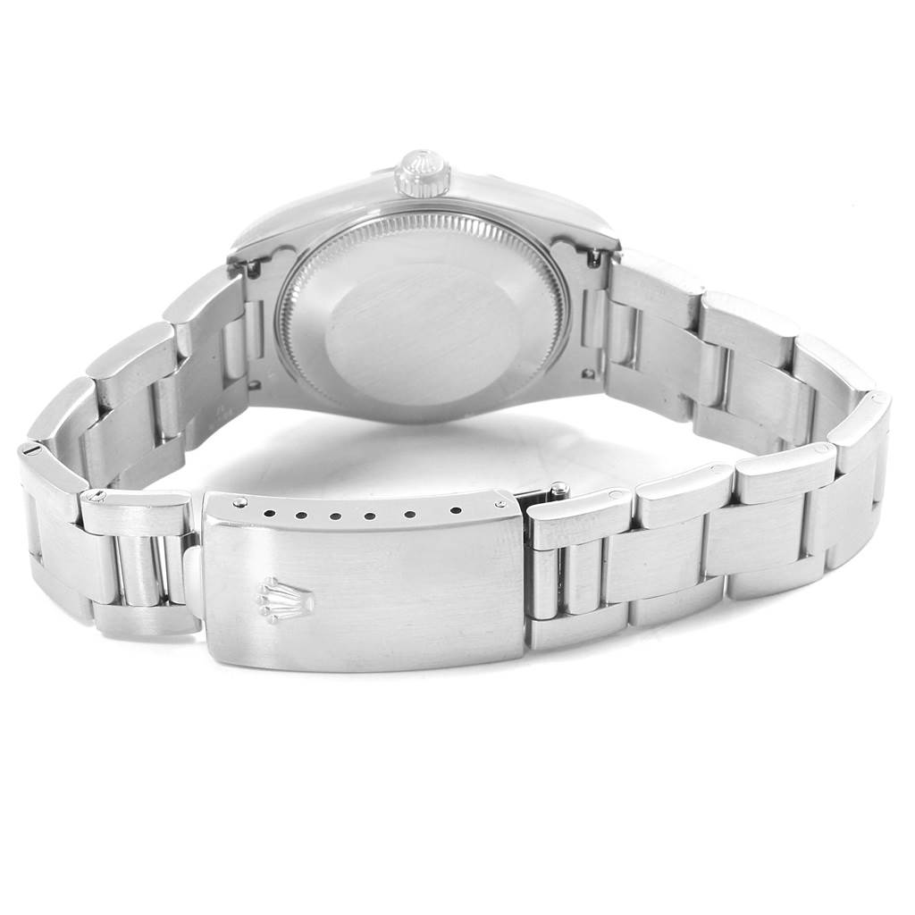 The image shows the back view of the Mid-Size Rolex watch, highlighting the case back, bracelet, and clasp.