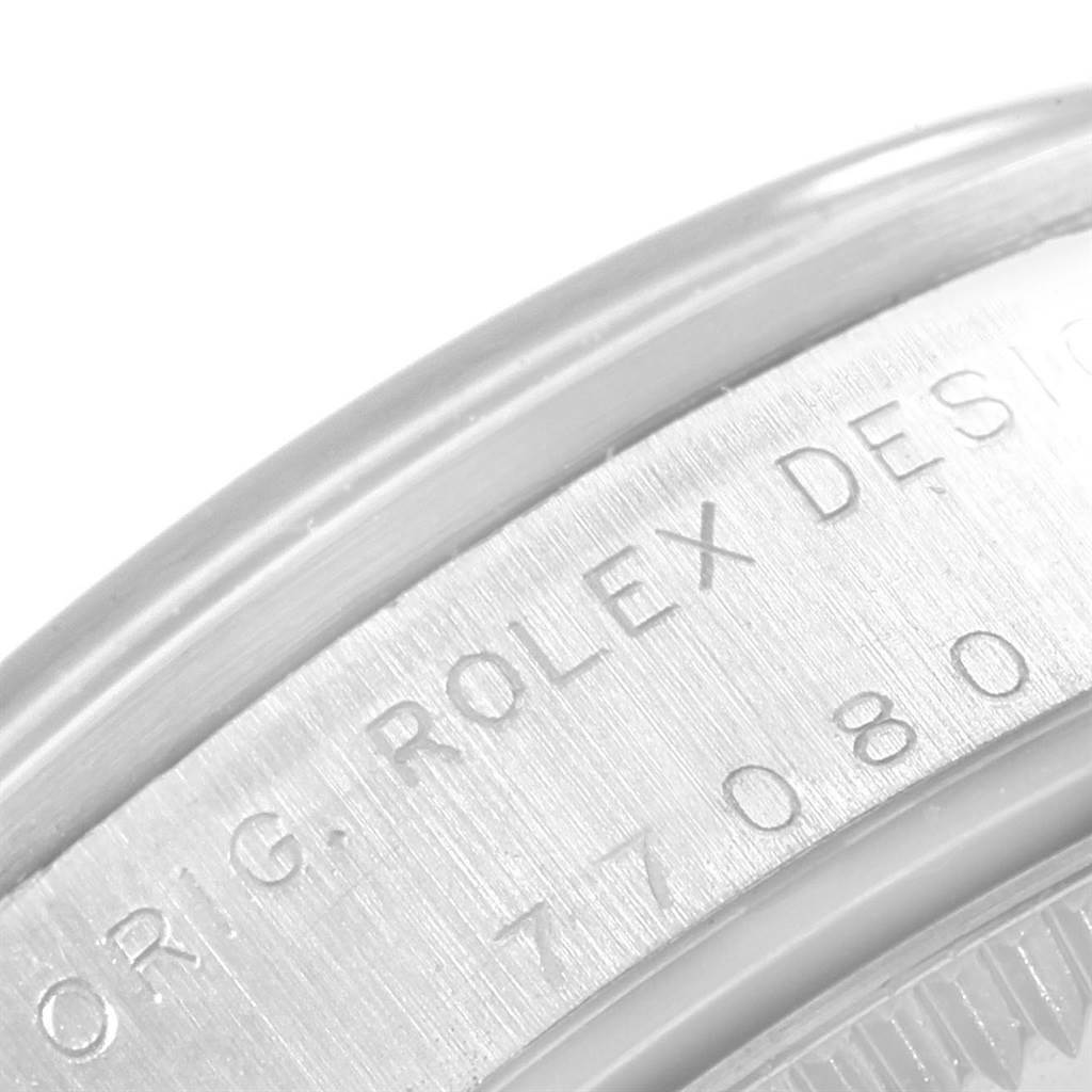 This close-up of a mid-size Rolex watch shows the engraved text on the case, highlighting "ROLEX DESIGN" and a serial number.