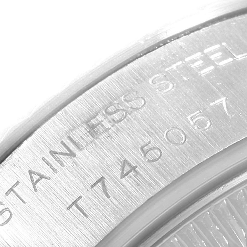 This image shows a close-up of the stainless steel back casing of a Rolex Mid-Size 69174 Women's Stainless Steel White Dial 69174 Women's Stainless Steel White Dial model watch with visible inscriptions.