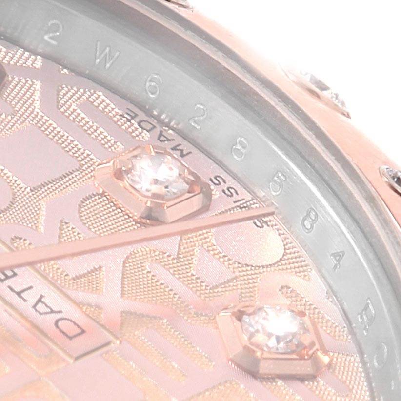 This close-up image of a mid-size Rolex watch shows part of the dial, indicating the brand name, diamond hour markers, and hands.