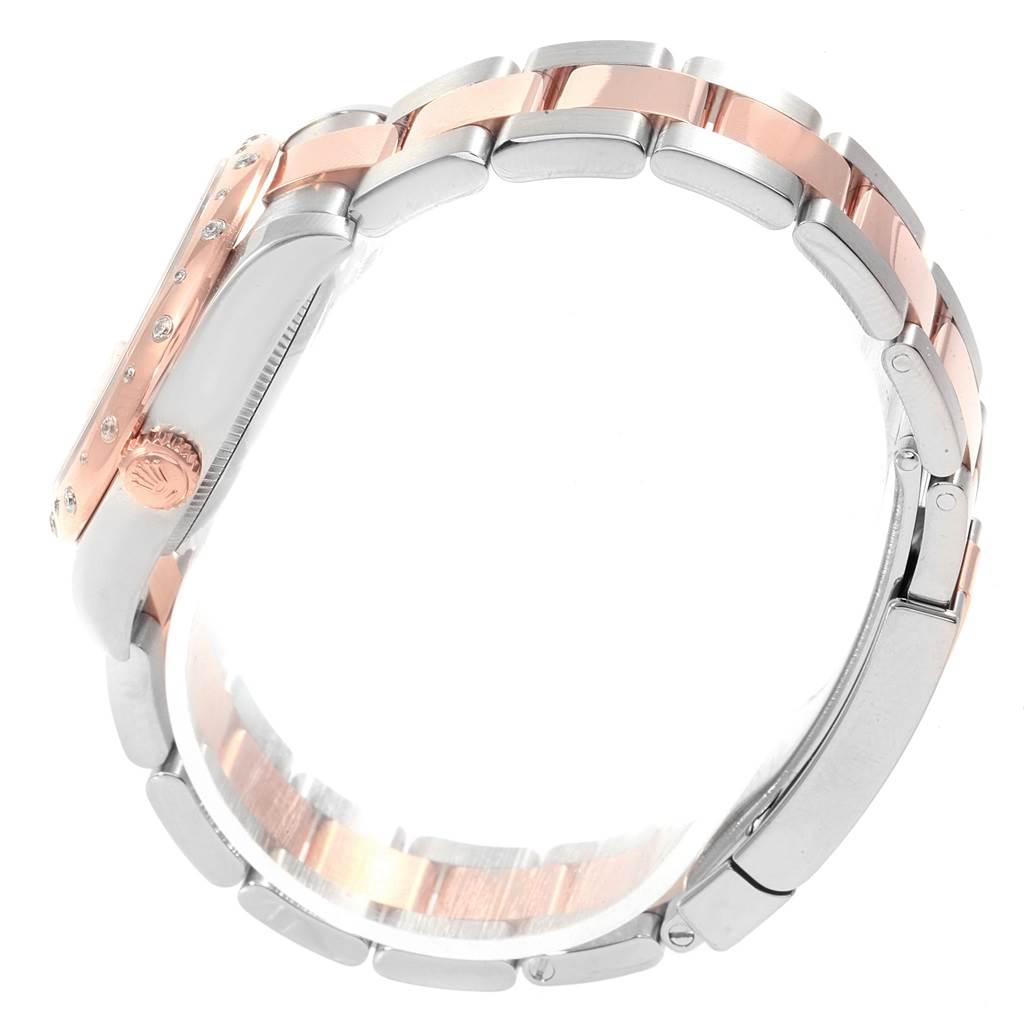 The image shows a side view of a Rolex Mid-Size 178341 Women's Steel and Gold (two tone) Pink Dial 178341 Women's Steel and Gold (two tone) Pink Dial watch, highlighting the crown, bezel, and two-tone bracelet.