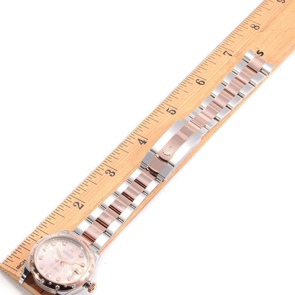 The image shows a Rolex Mid-Size 178341 Women's Steel and Gold (two tone) Pink Dial 178341 Women's Steel and Gold (two tone) Pink Dial model watch placed alongside a ruler, focusing on the bracelet and clasp from an overhead angle.