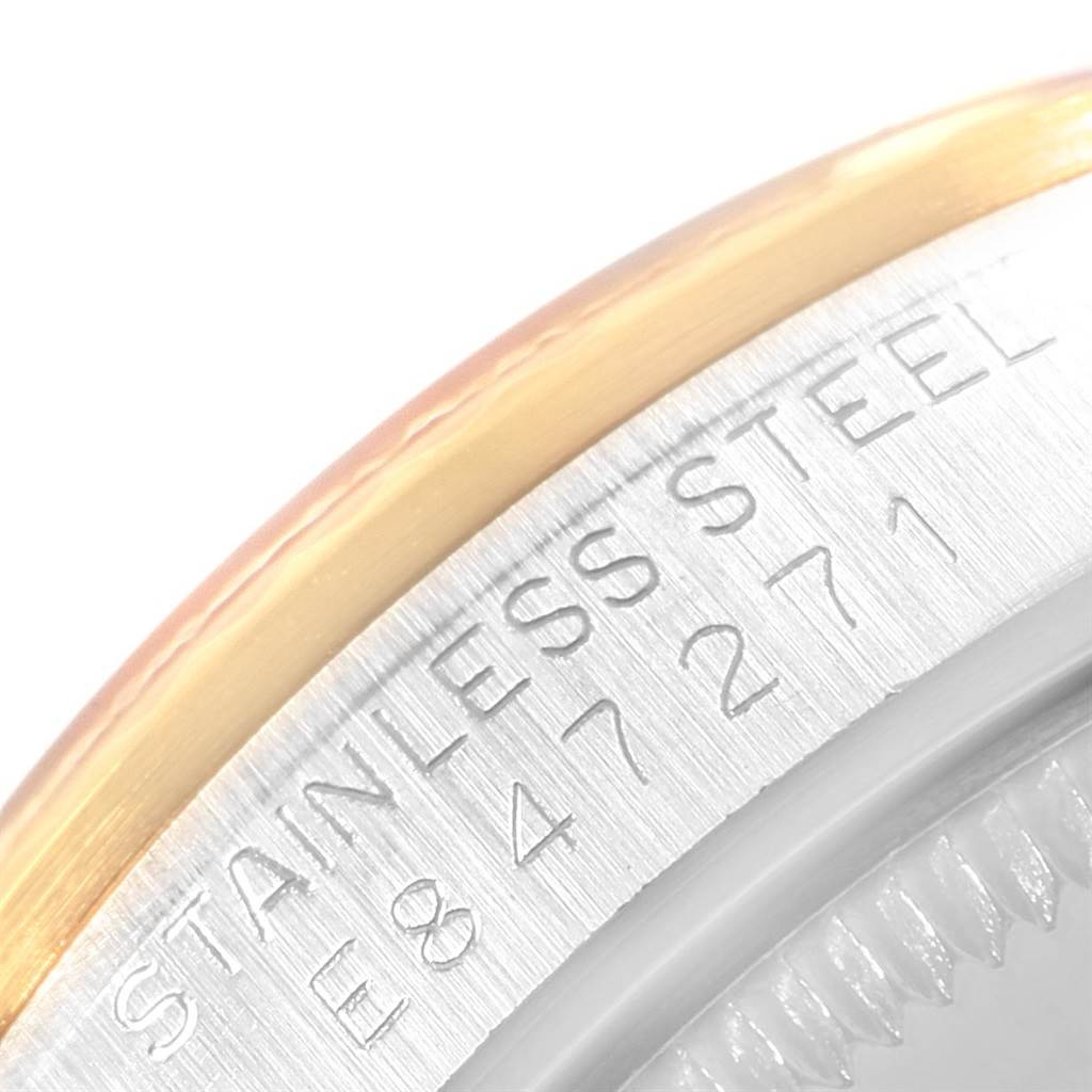 This image shows a close-up angle of the casing side of a Mid-Size Rolex watch, highlighting the stainless steel marking and part of the bezel.