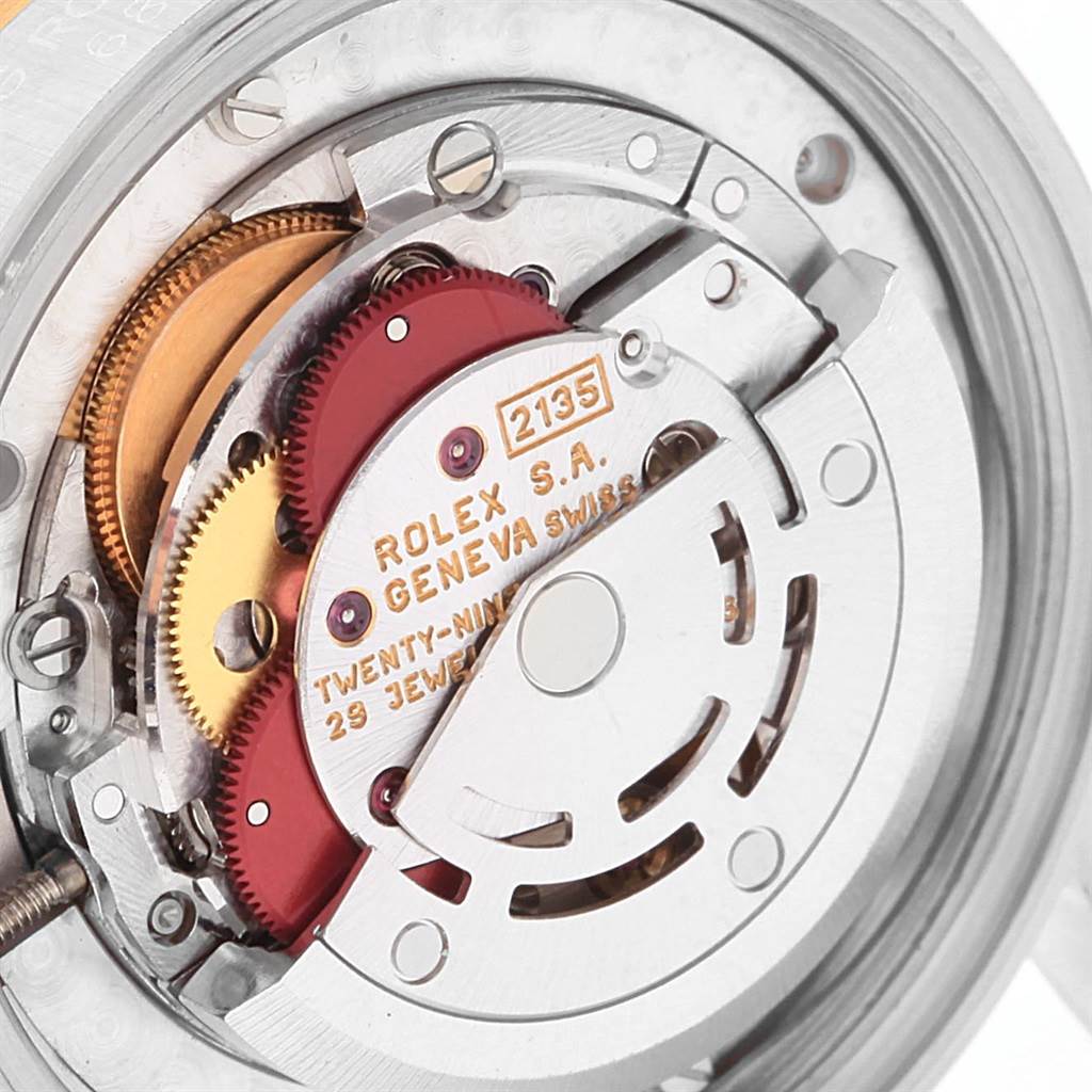 This is a close-up view of the internal mechanism of a Rolex Mid-Size 68273 Women's Steel and Gold (two tone) Champagne Dial 68273 Women's Steel and Gold (two tone) Champagne Dial model watch, showing its intricate components and engravings.