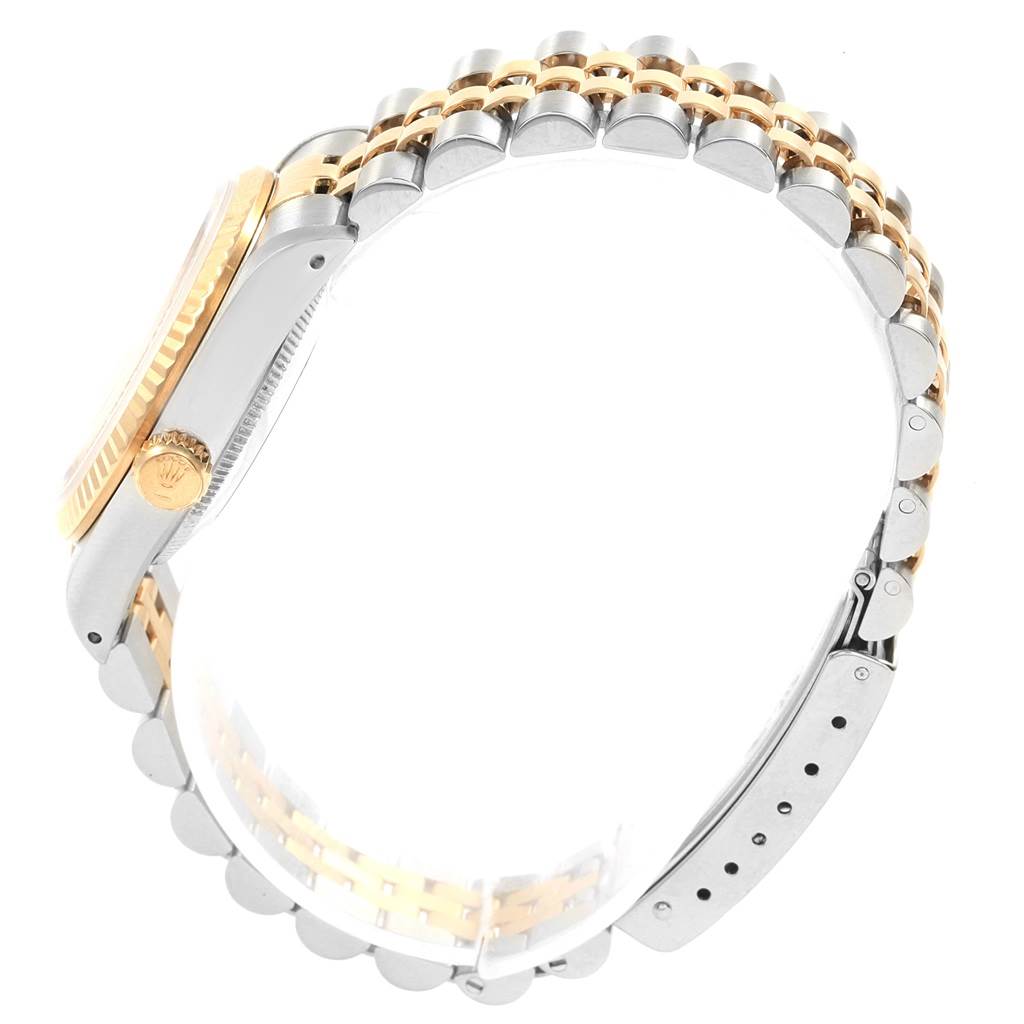 The image shows a side profile of a Rolex Mid-Size 68273 Women's Steel and Gold (two tone) Champagne Dial 68273 Women's Steel and Gold (two tone) Champagne Dial watch, highlighting its two-tone bracelet, case, crown, and clasp.