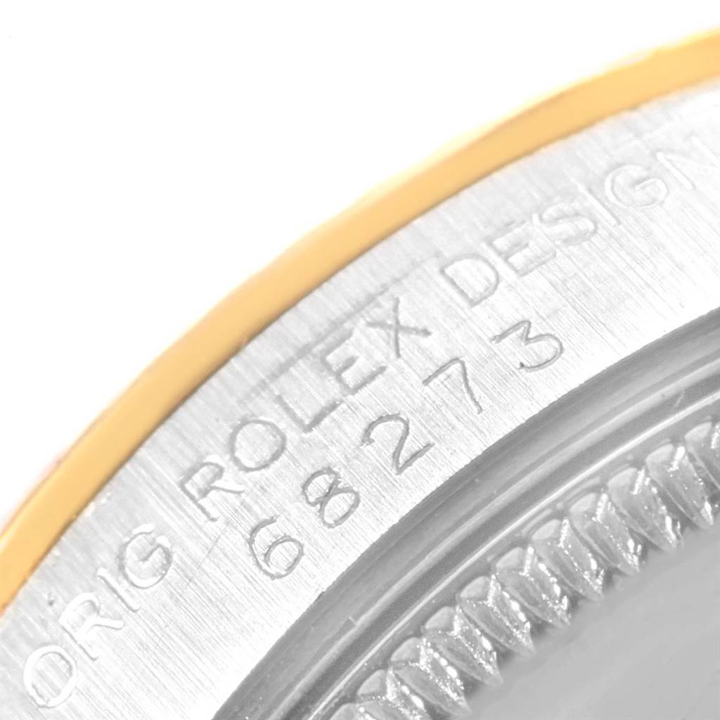 The image shows a close-up of the case side and bezel edge of a Rolex Mid-Size 68273 Women's Steel and Gold (two tone) Champagne Dial 68273 Women's Steel and Gold (two tone) Champagne Dial model, highlighting its engraving and metal finish.