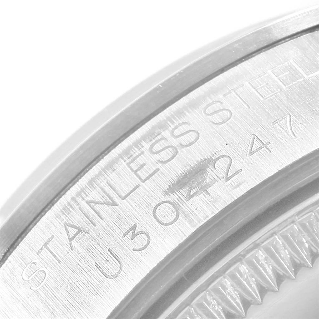 The image shows a close-up of the serial engraving on the stainless steel back of a Rolex Mid-Size 68240 Women's Stainless Steel White Dial 68240 Women's Stainless Steel White Dial model watch.