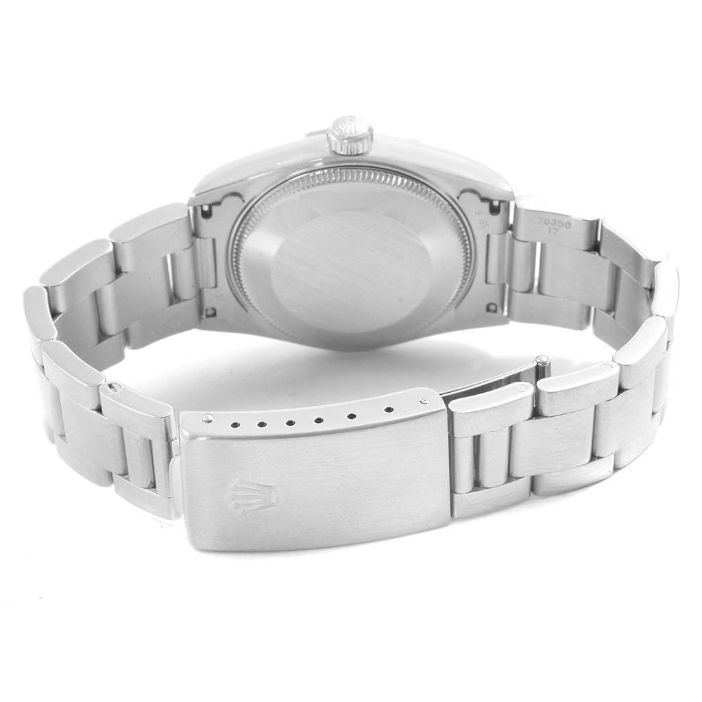 The image shows the back view of a Rolex Mid-Size 68240 Women's Stainless Steel White Dial 68240 Women's Stainless Steel White Dial model watch, highlighting its case back and metal bracelet with clasp.
