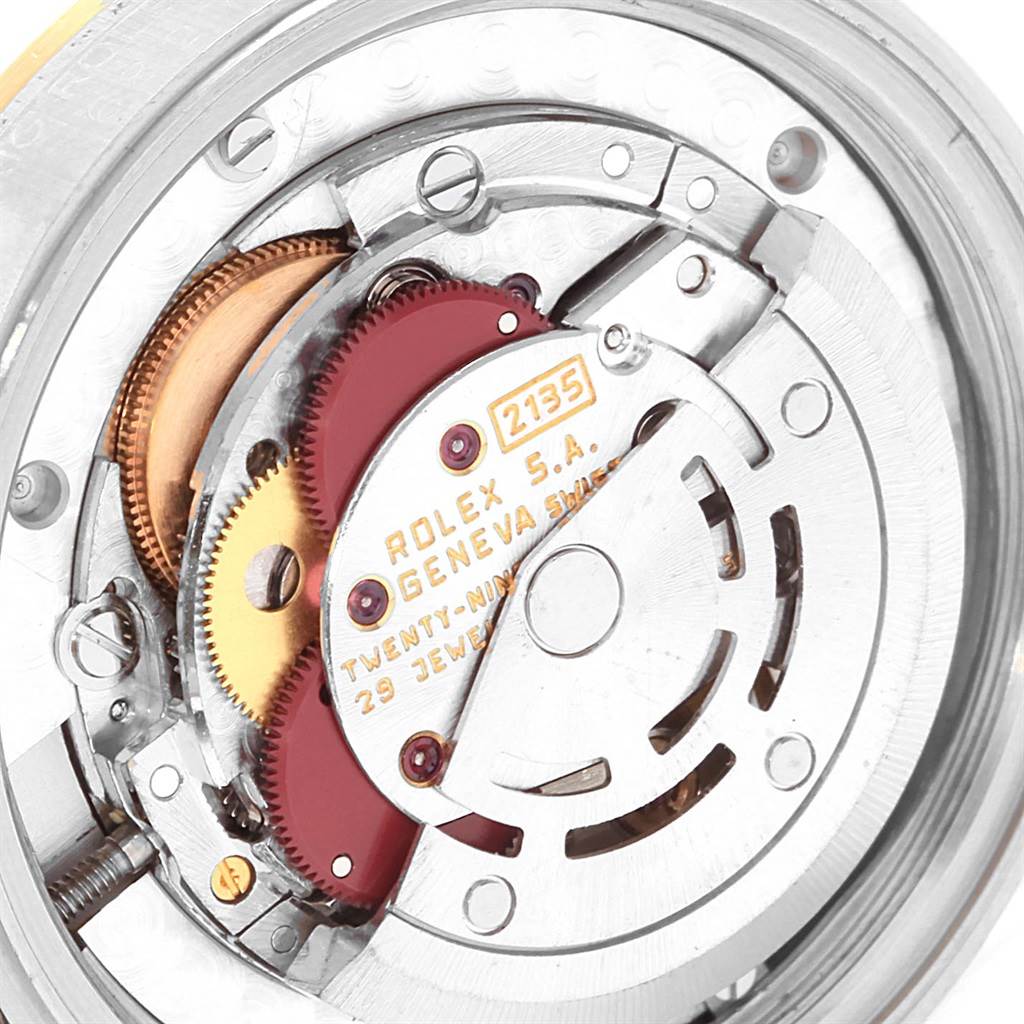 The image shows a close-up view of the internal movement of a Rolex Mid-Size 68273 Women's Steel and Gold (two tone) Champagne Dial 68273 Women's Steel and Gold (two tone) Champagne Dial model, highlighting gears and other mechanical components.