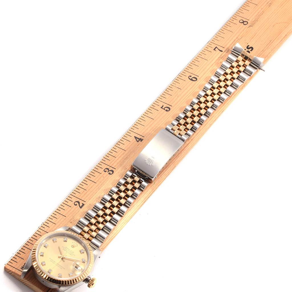 This image displays a Mid-Size Rolex watch laid flat with both the watch face and bracelet fully visible.