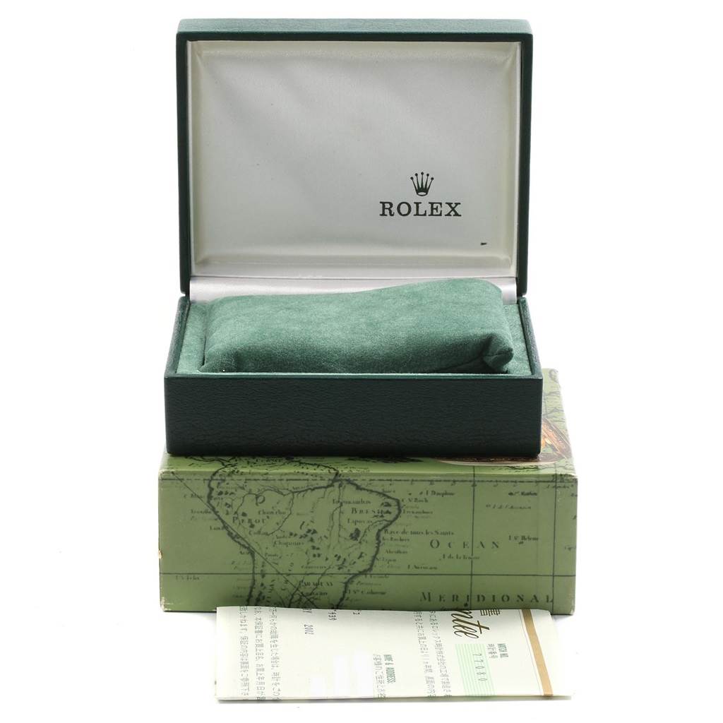 This image shows the green box and green cushion of a Rolex Mid-Size 77080 Women's Stainless Steel Blue Dial 77080 Women's Stainless Steel Blue Dial model watch along with some paperwork.