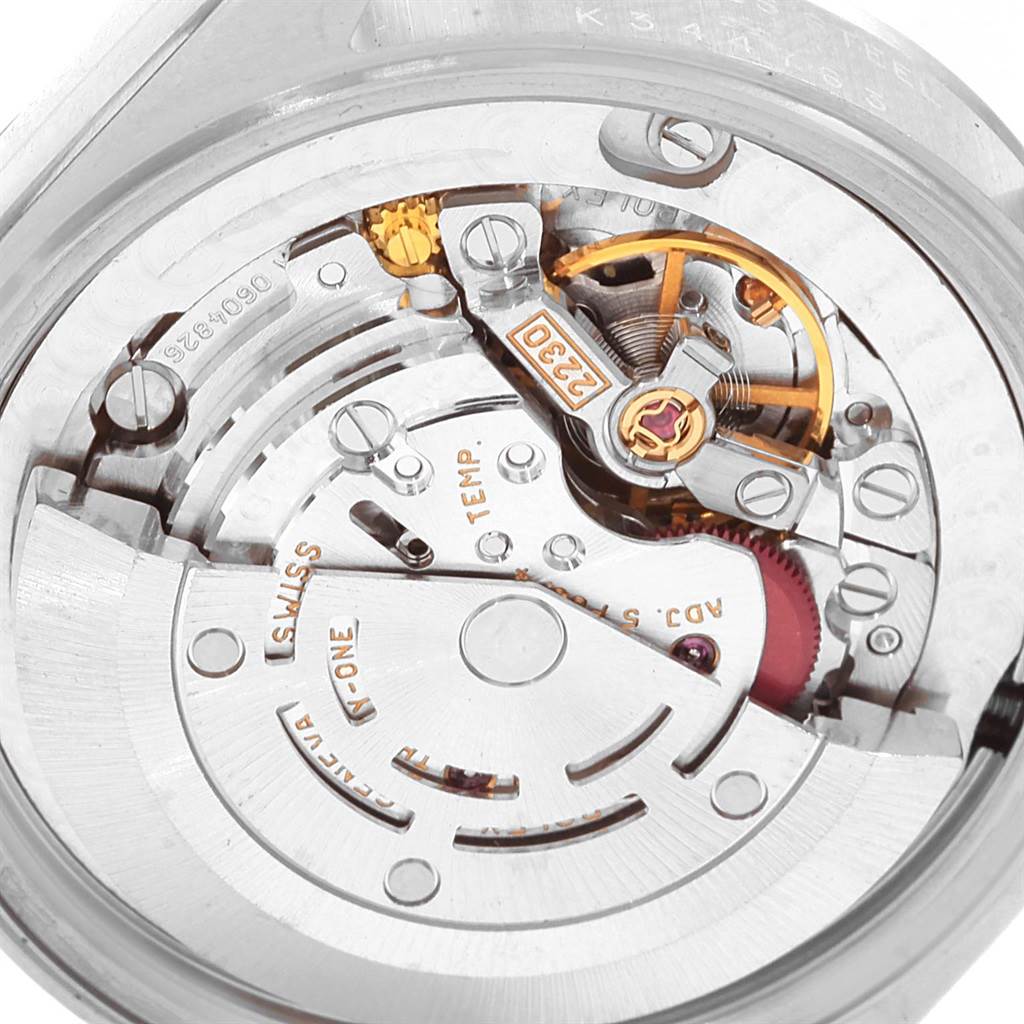 The image shows a close-up view of the inner mechanical parts of a Rolex Mid-Size 77080 Women's Stainless Steel Blue Dial 77080 Women's Stainless Steel Blue Dial model watch, including gears and the balance wheel.