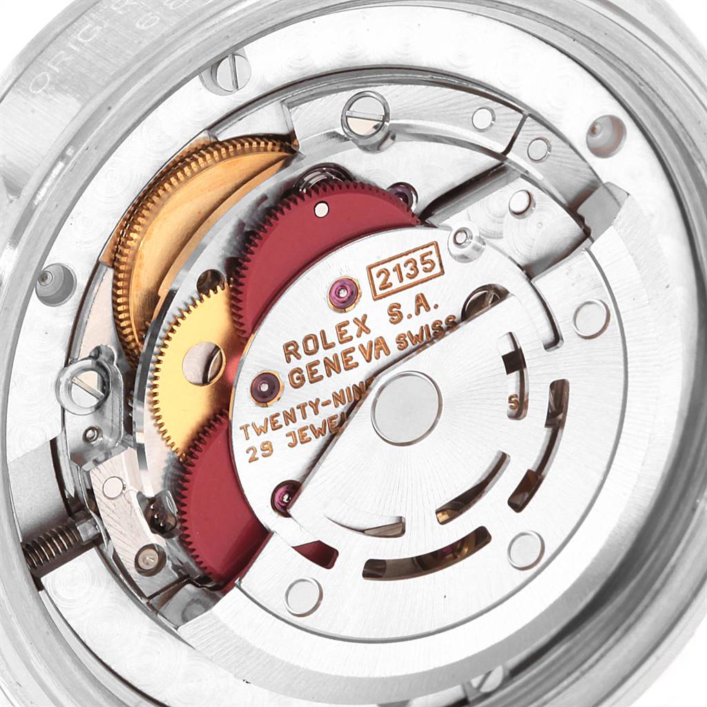 This image shows the internal components of the Rolex Mid-Size 68240 Women's Stainless Steel White Dial 68240 Women's Stainless Steel White Dial watch from an angled view, revealing gears and inscriptions.