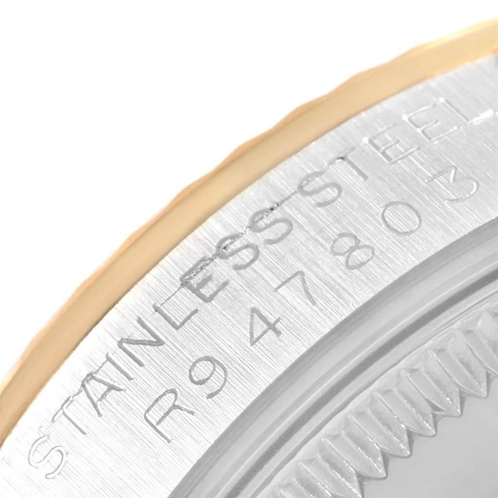 This close-up angle shows the engraved stainless steel case back of a Mid-Size Rolex watch.