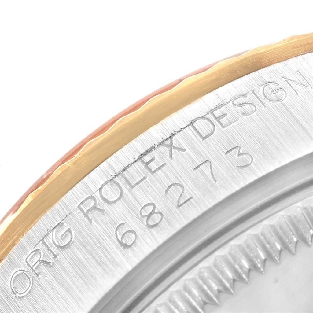 The close-up angle shows the side of a Mid-Size Rolex watch, featuring part of the bezel and engraved model number "68273".