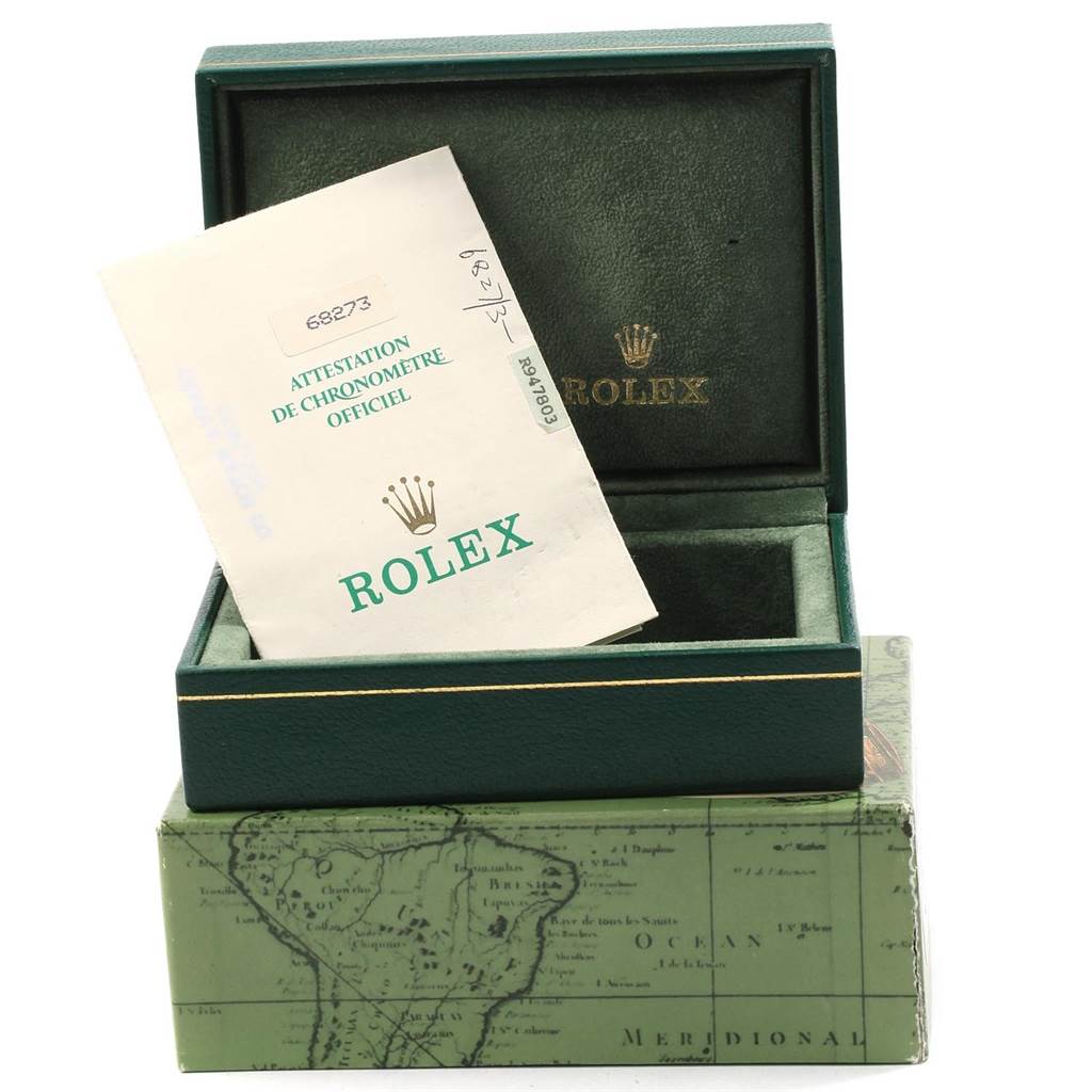 The image shows an open green Rolex box with a certificate for a Mid-Size Rolex watch inside.