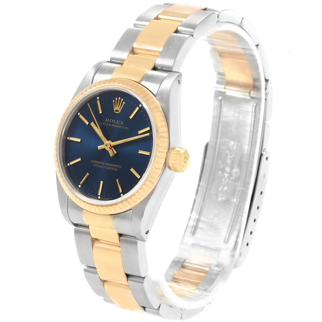 This Rolex Mid-Size 67513 Women's Steel and Gold (two tone) Blue Dial 67513 Women's Steel and Gold (two tone) Blue Dial watch is shown at a three-quarter angle, displaying its two-tone bracelet, blue dial, and gold bezel.