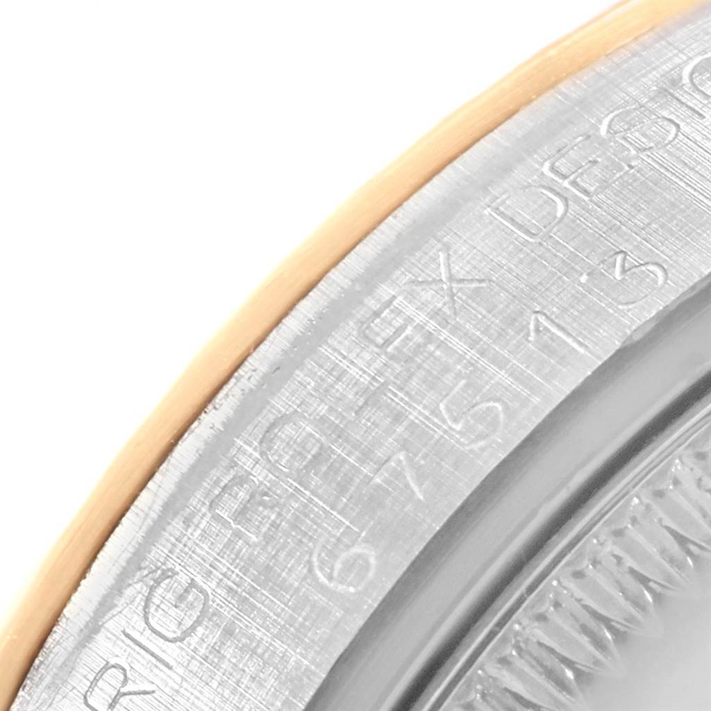 The image shows a close-up of the engraved side and bezel edge of a Rolex Mid-Size 67513 Women's Steel and Gold (two tone) Blue Dial 67513 Women's Steel and Gold (two tone) Blue Dial watch.