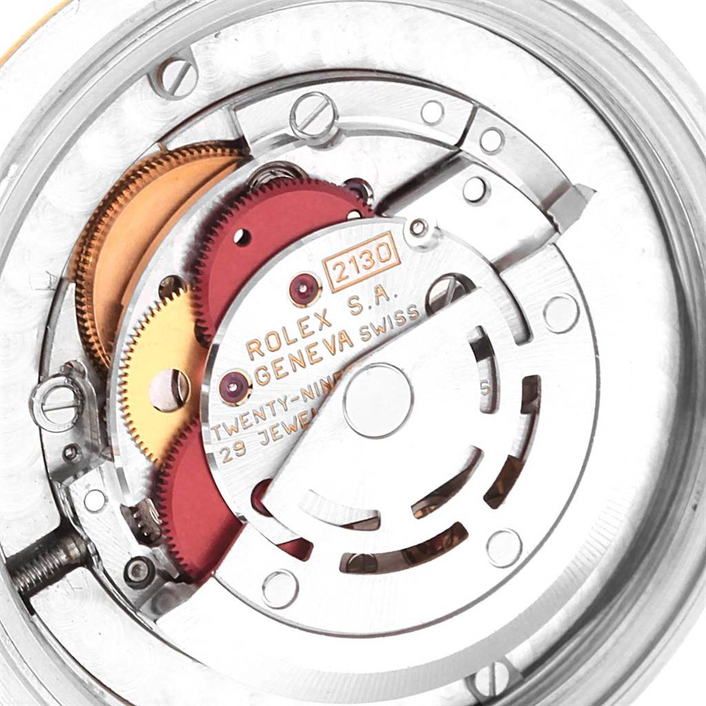 This image shows a close-up view of the internal mechanism of a Rolex Mid-Size 67513 Women's Steel and Gold (two tone) Blue Dial 67513 Women's Steel and Gold (two tone) Blue Dial model watch, focusing on its intricate gears and movements.