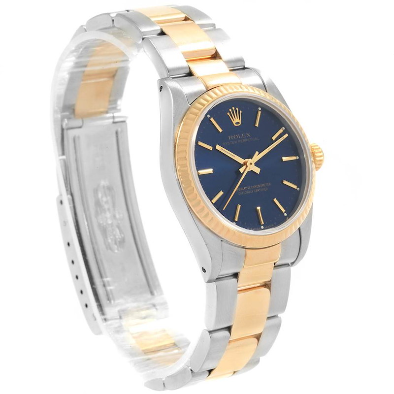 This image shows a Rolex Mid-Size model watch at an angled view highlighting its blue dial, gold bezel, and two-tone bracelet.