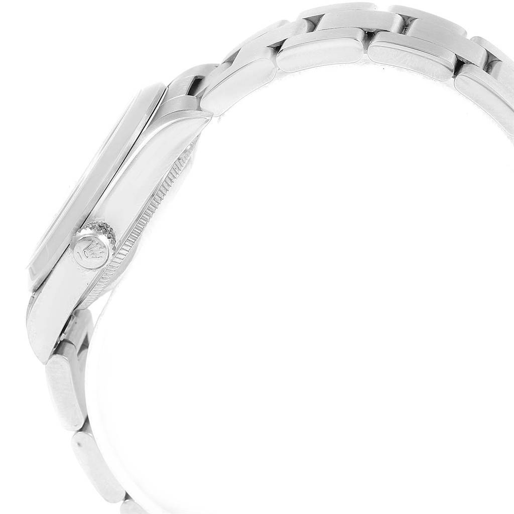 This image shows the side view of a Rolex Mid-Size 78240 Women's Stainless Steel Blue Dial 78240 Women's Stainless Steel Blue Dial watch, displaying the case, crown, and part of the bracelet.