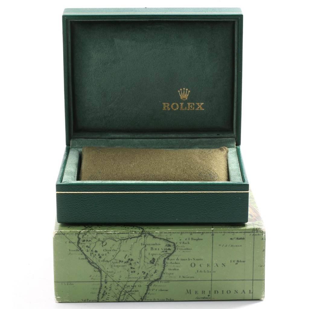 This image shows an open Rolex watch box, including the green interior and exterior with the Rolex logo.