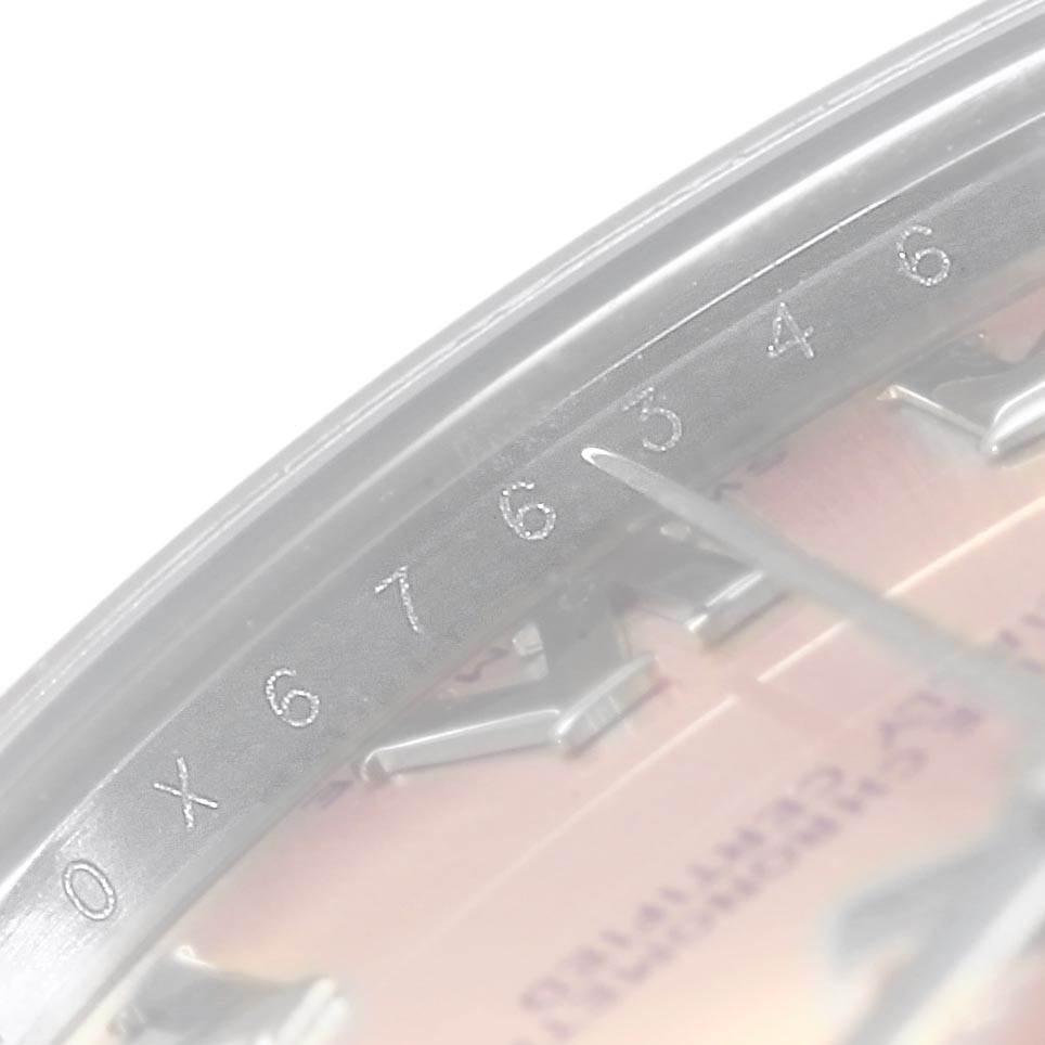 The image shows a close-up of the dial and minute markers on a Mid-Size Rolex watch.