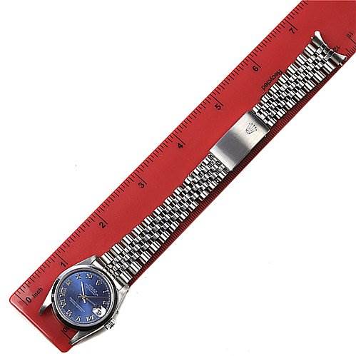The image shows a top view of a Mid-Size Rolex watch with a blue dial, silver bracelet, and deployment clasp, placed aligned with a red ruler.