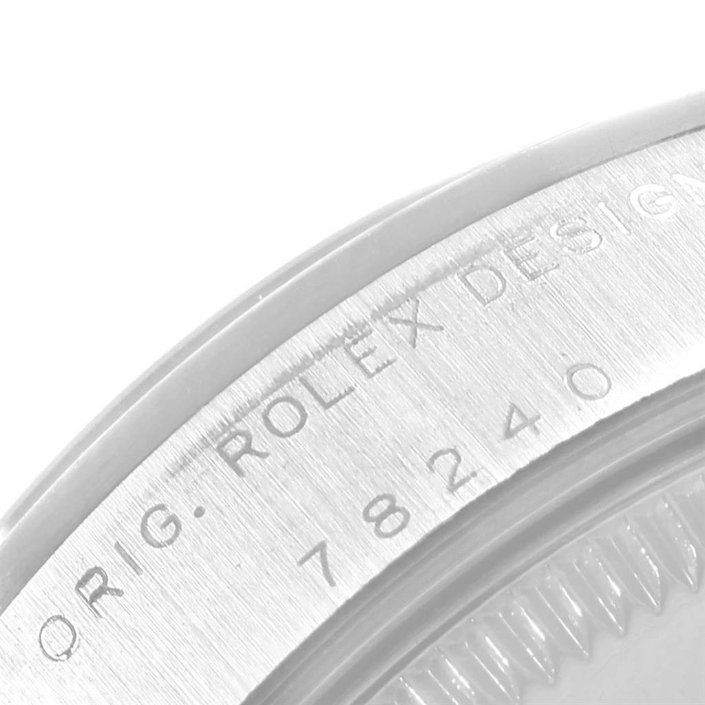 The image shows a close-up of the bezel and serial number area of a Rolex Mid-Size 78240 Women's Stainless Steel Blue Dial 78240 Women's Stainless Steel Blue Dial model watch.