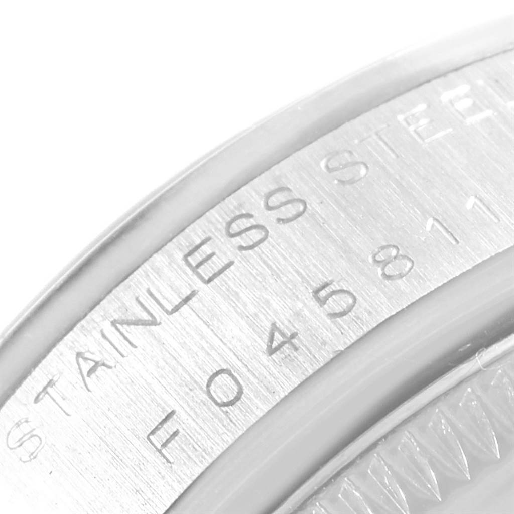 This close-up image shows the stainless steel case back and part of the serial number of a Rolex Mid-Size 78240 Women's Stainless Steel Blue Dial 78240 Women's Stainless Steel Blue Dial model watch.