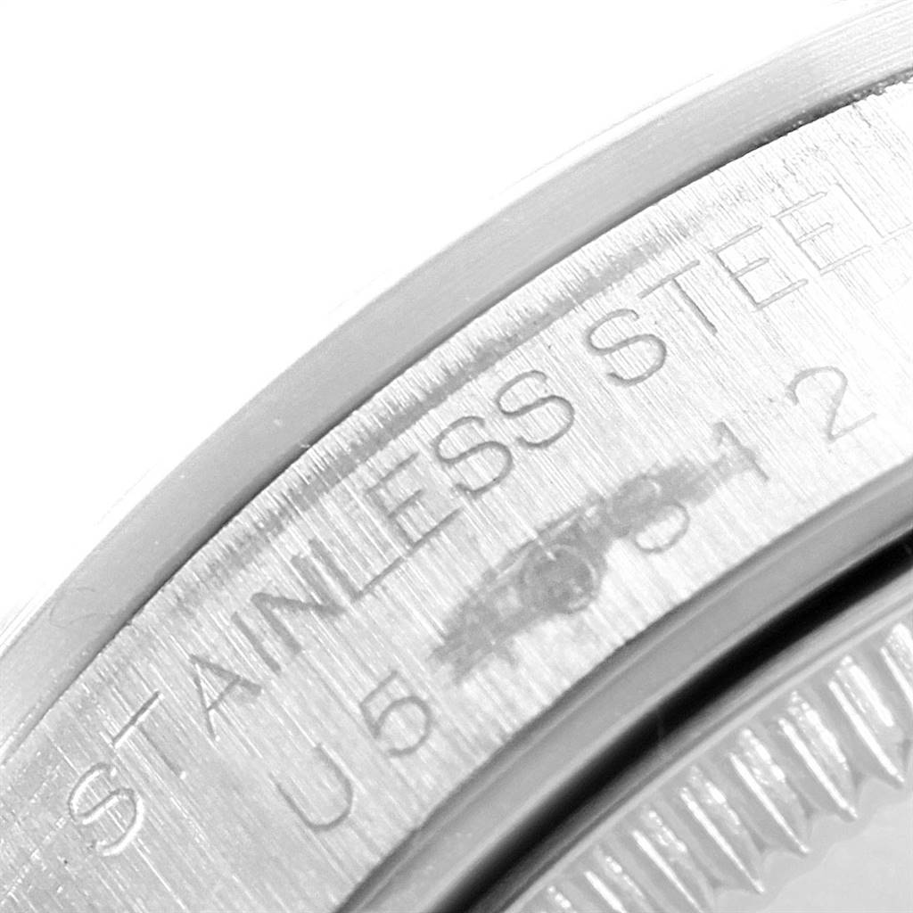 The image shows a close-up of the engraved stainless steel bezel of a Mid-Size Rolex watch.