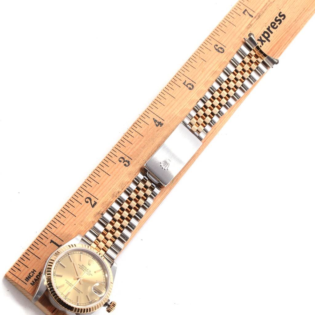 This image shows an overhead view of a Rolex Mid-Size 68273 Women's Steel and Gold (two tone) Champagne Dial 68273 Women's Steel and Gold (two tone) Champagne Dial model watch, including the face, bezel, and bracelet with ruler for scale.