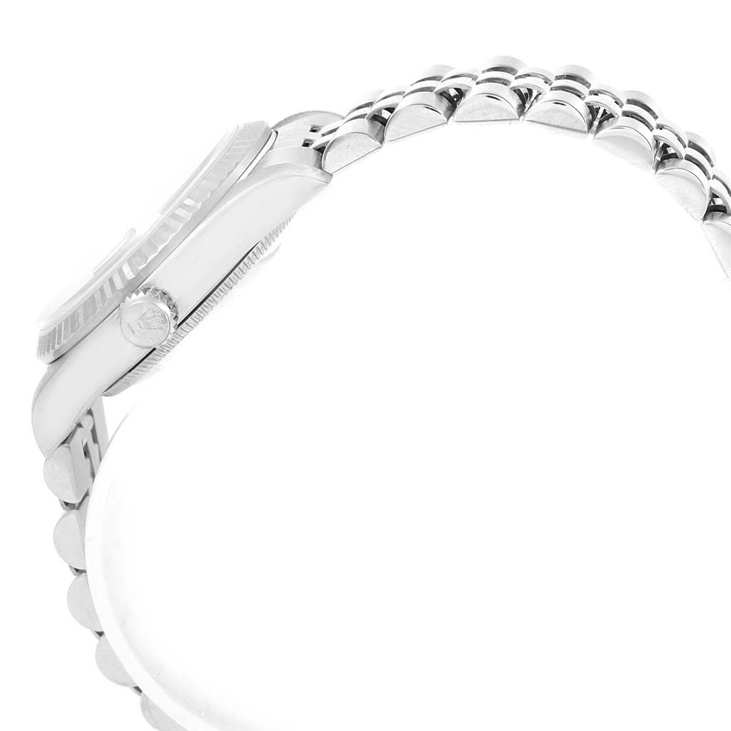 The image shows a side view of a Mid-Size Rolex watch, focusing on the crown, case, and a segment of the bracelet.