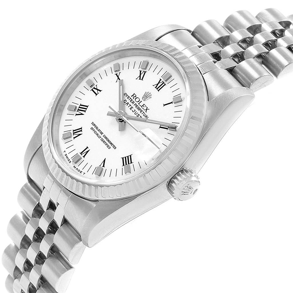 The image shows a close-up angle of a Rolex Mid-Size 68274 Women's Stainless Steel White Dial 68274 Women's Stainless Steel White Dial Datejust watch, highlighting its white dial, Roman numerals, bezel, crown, and metal bracelet.