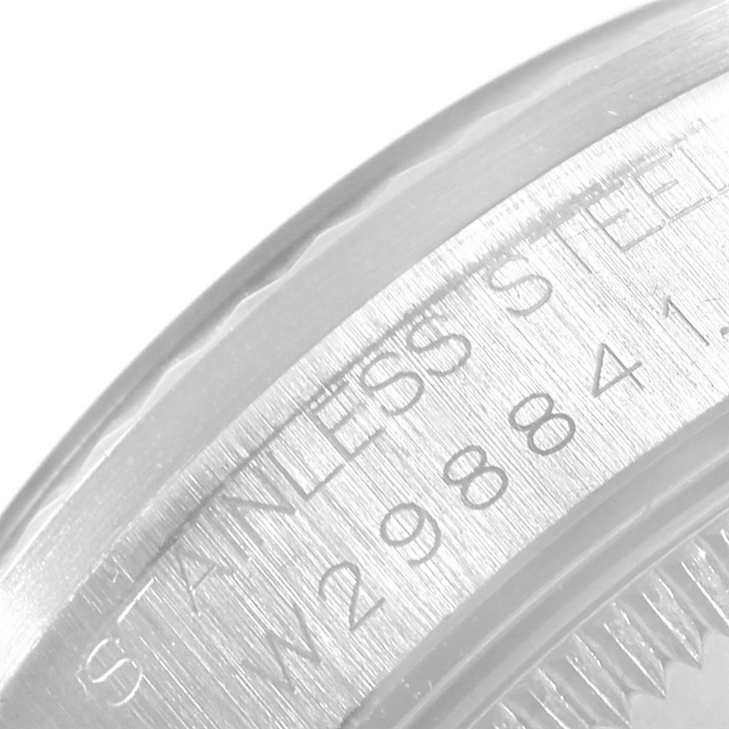 This image shows a close-up of the side of a Rolex Mid-Size 68274 Women's Stainless Steel White Dial 68274 Women's Stainless Steel White Dial watch, highlighting the engraved serial number and stainless steel text.