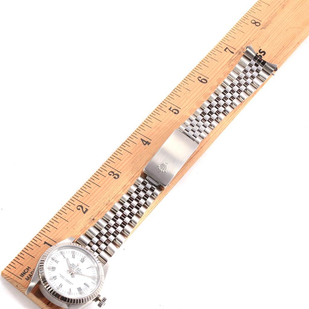 The Rolex Mid-Size 68274 Women's Stainless Steel White Dial 68274 Women's Stainless Steel White Dial watch is shown flat, displaying the face, bracelet, and clasp, measured against a wooden ruler.