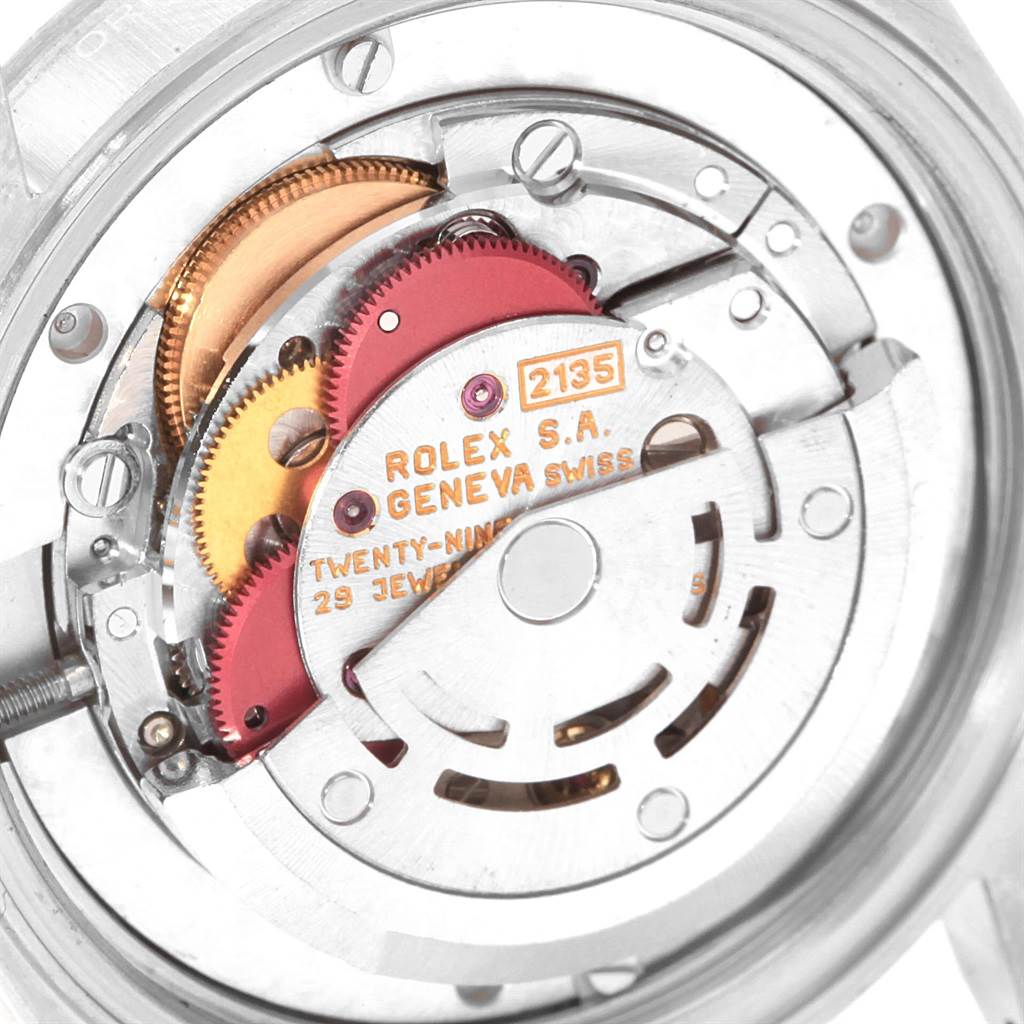 The image shows the internal mechanical movement of a Mid-Size Rolex watch, highlighting gears and the rotor.