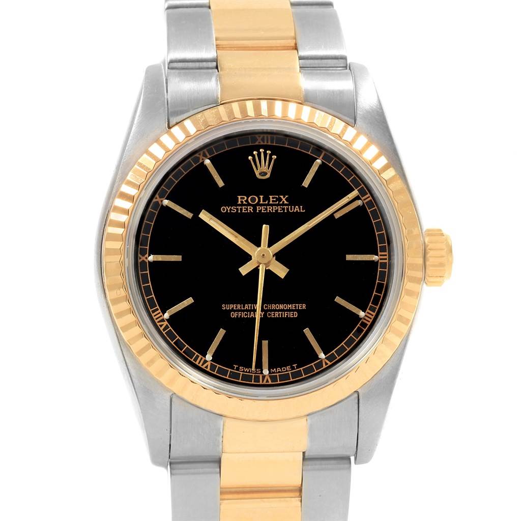 This image shows a front view of a Mid-Size Rolex Oyster Perpetual watch, highlighting the black dial, gold crown and bezel, and two-tone bracelet.