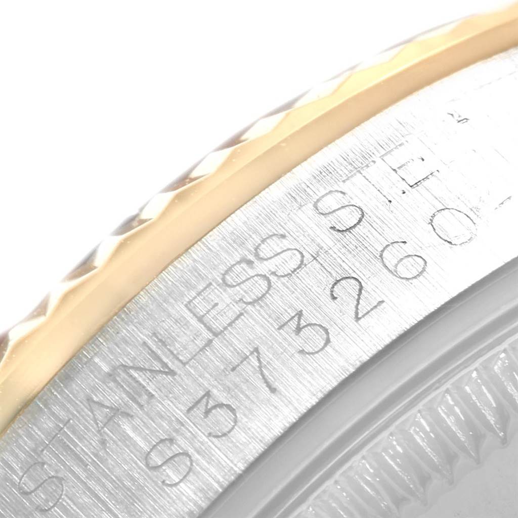 The image shows a close-up of the bezel and case side of a Mid-Size Rolex watch, featuring the model's engraving.