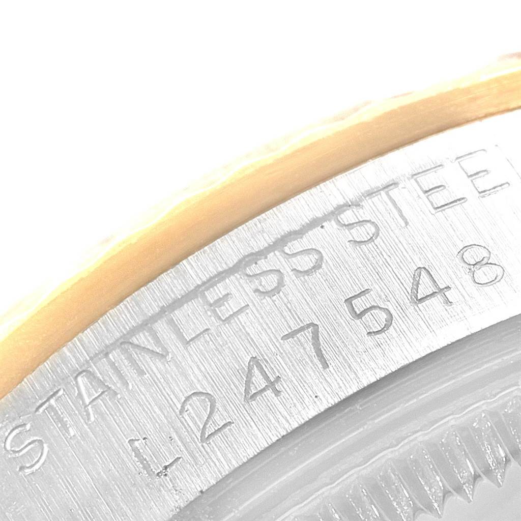 The image shows a close-up of the serial number and "STAINLESS STEEL" engraving on the Rolex Mid-Size 68273 Women's Steel and Gold (two tone) Champagne Dial 68273 Women's Steel and Gold (two tone) Champagne Dial watch casing.