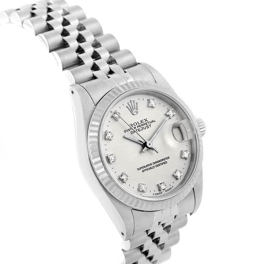 This image shows a Rolex Mid-Size 68274 Women's Stainless Steel Silver Dial 68274 Women's Stainless Steel Silver Dial Datejust watch at an angled view, highlighting the dial, bezel, and part of the bracelet.