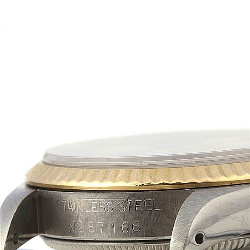 The image shows a side view of a Rolex Mid-Size 67513 Women's Stainless Steel Silver Dial 67513 Women's Stainless Steel Silver Dial watch focusing on the bezel, crown guard, and part of the stainless steel case.