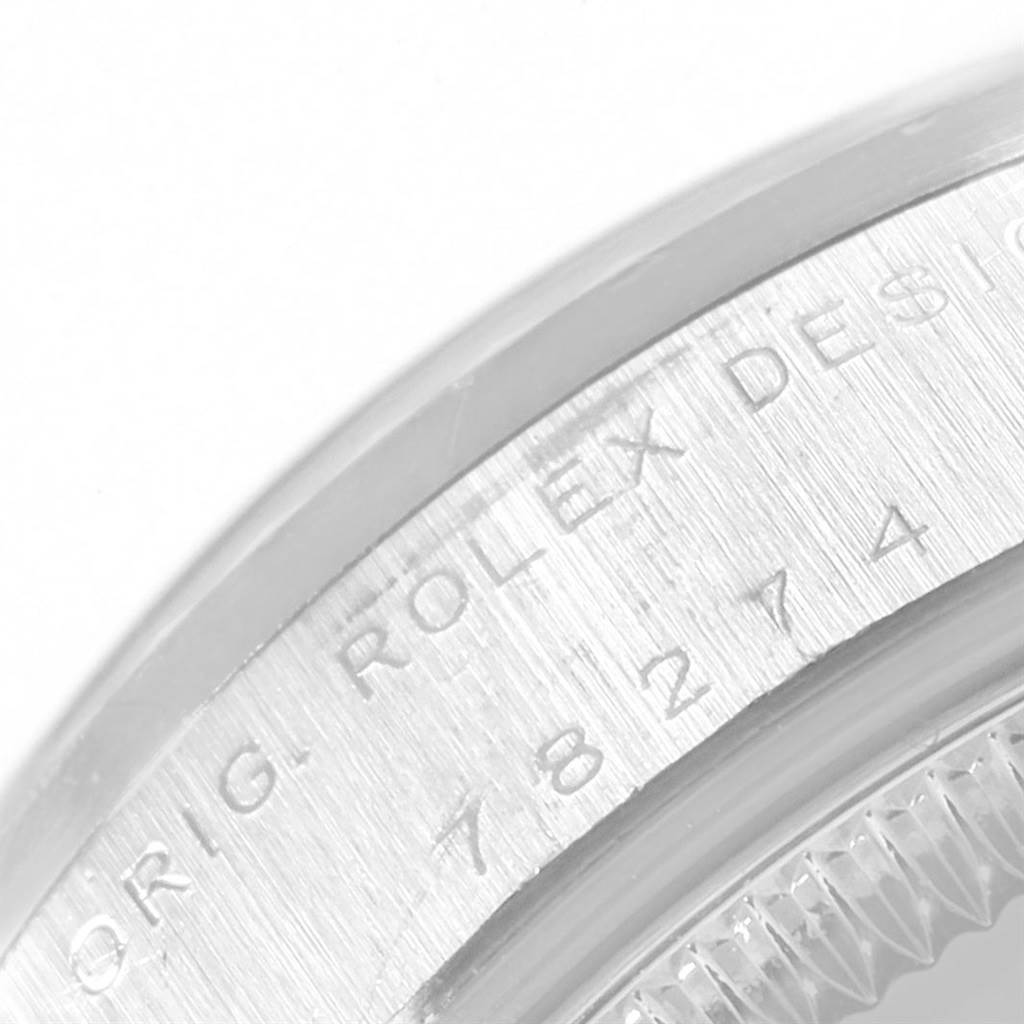 This close-up image shows the engraved bezel with the model number of a Mid-Size Rolex watch.