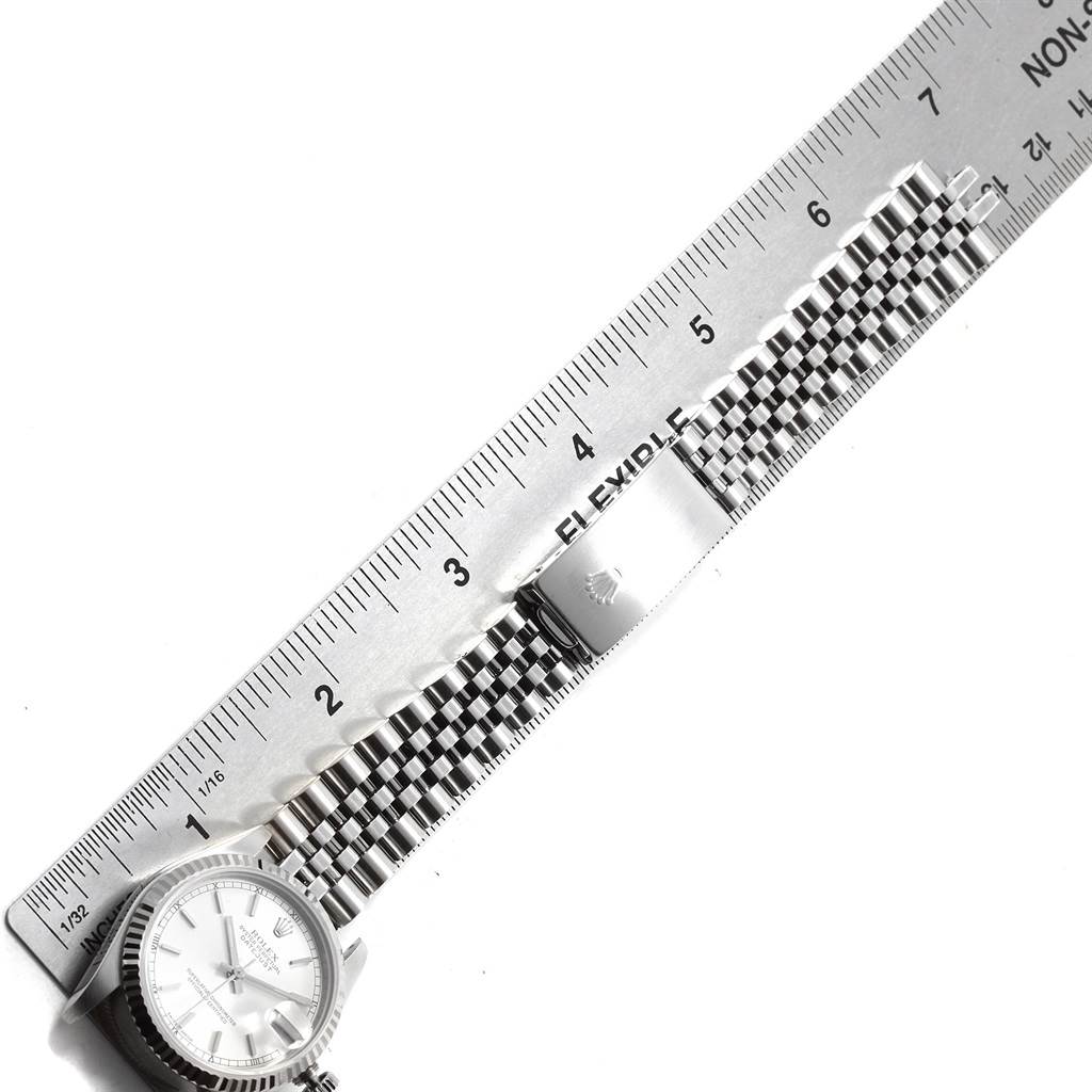 The image shows a Mid-Size Rolex watch with a stainless steel bracelet and clasp, alongside a measuring ruler.