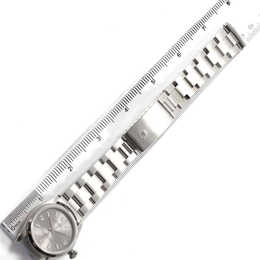 The Rolex Mid-Size 77080 Women's Stainless Steel Silver Dial 77080 Women's Stainless Steel Silver Dial model watch is shown laid flat with the entire bracelet and clasp visible alongside a ruler for scale.